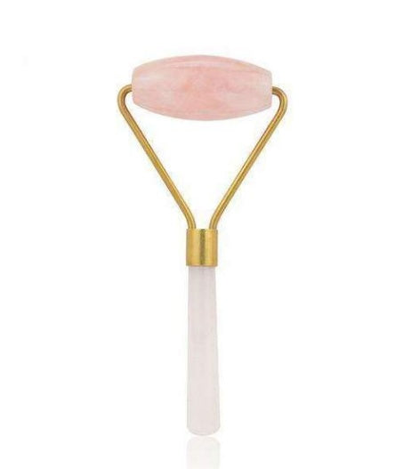Beauty roller with pink jade ball on a white background