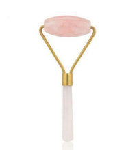 Beauty roller with pink jade ball on a white background