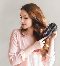 Woman using a hairbrush with text about ionic technology on a light pink background