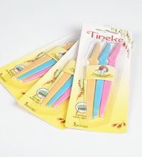 Set of colorful cutlery sets with 'Tineke' packaging on a light blue background.