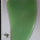 Green plastic object on a white surface