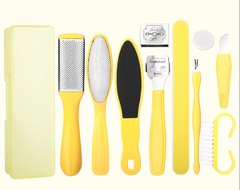 Set of yellow foot care tools including a file, scrubber, and other items on a white background.