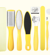 Set of yellow foot care tools including a file, scrubber, and other items on a white background.