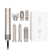 Hair styling tool with multiple attachments and packaging on a white background