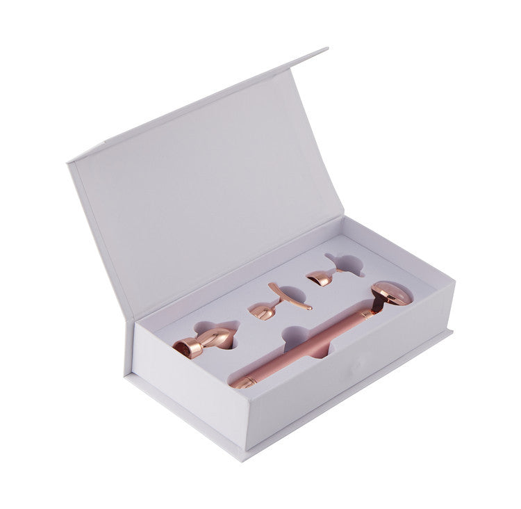 Rose gold ice cream scoop set in a white box on a white background