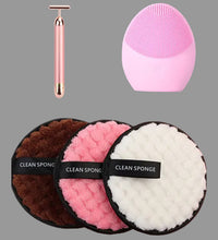 Set of cleaning sponges with a pink facial cleansing brush on a white background