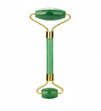 Jade facial roller with gold accents on a white background