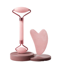 Pink rose quartz facial roller with a dual-headed design for eyes and face.
