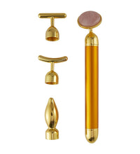 Gold facial roller with multiple attachments on a white background