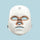 White facial mask with bronze accents on a white background