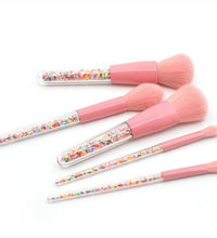 Close-up of pink synthetic makeup brush bristles showing soft texture and uniform shape.